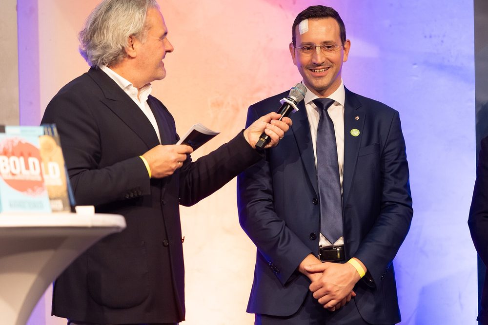 A speaker being interviewed on stage